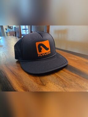 Flylow Men's Black Trucker Hat with Orange Logo
